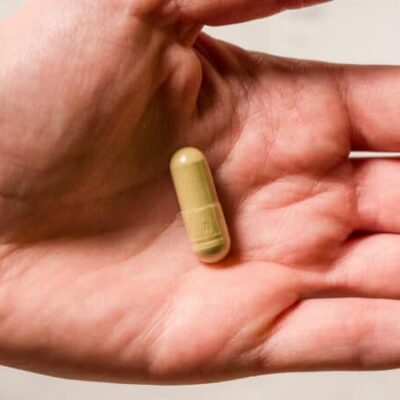 emerald select enhanced enhanced kratom capsules in hand